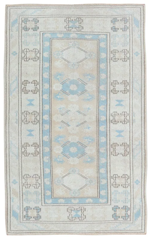 Full top view of the 4x7 beige and blue vintage Anatolian rug on a white background.