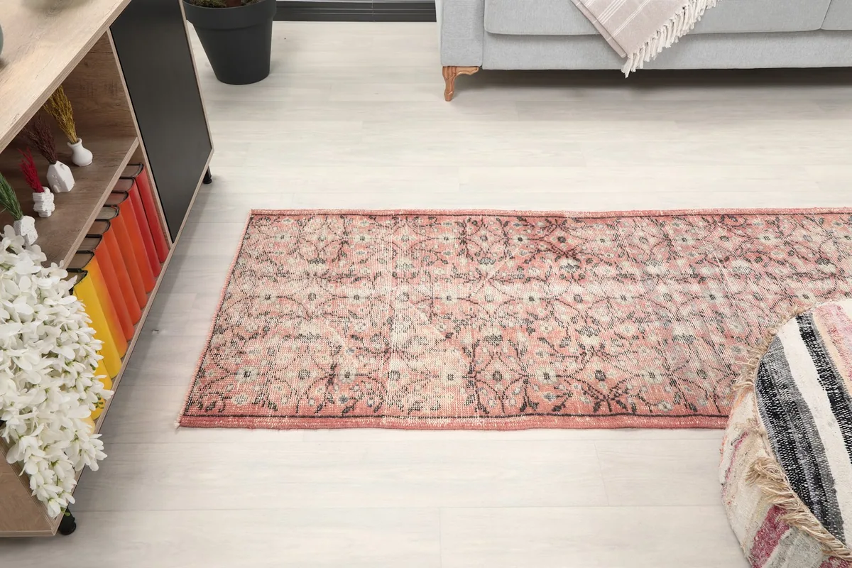 Angled view of the runner rug in a room, emphasizing its long, narrow shape and how it defines the space.