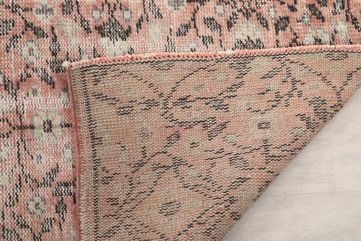 Another view of the rug's underside, showing the consistent knotting and the quality of the cotton foundation.