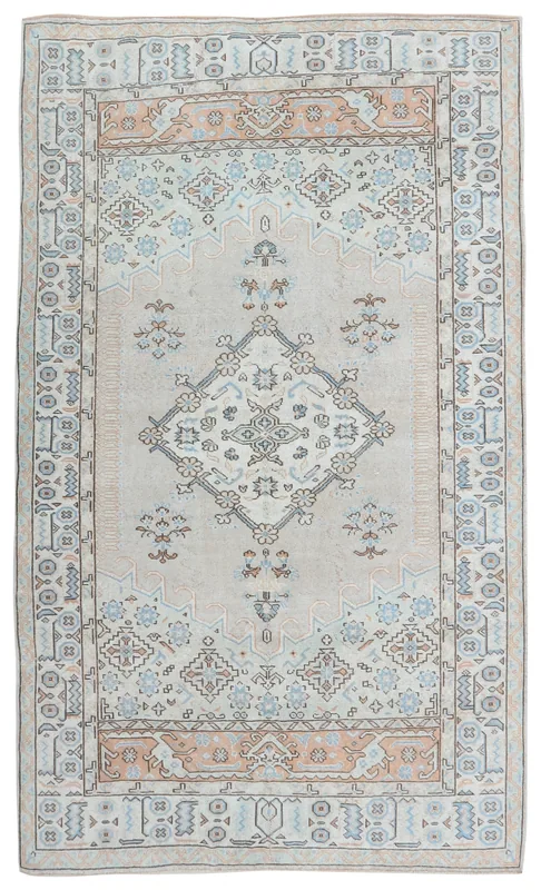 Full overhead view of the hand-knotted vintage Anatolian area rug with ivory field and rust, blue tribal patterns