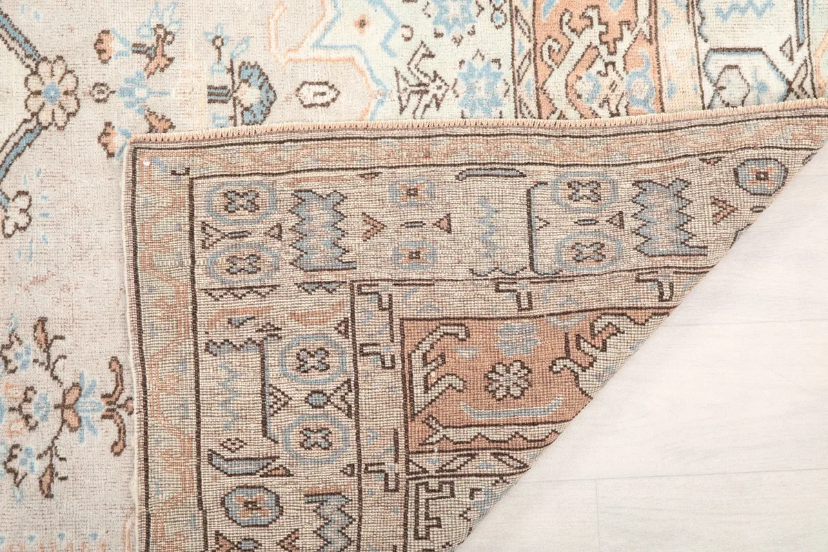 Close-up of the rug's reverse side, showing the dense hand-knotting and a corner detail