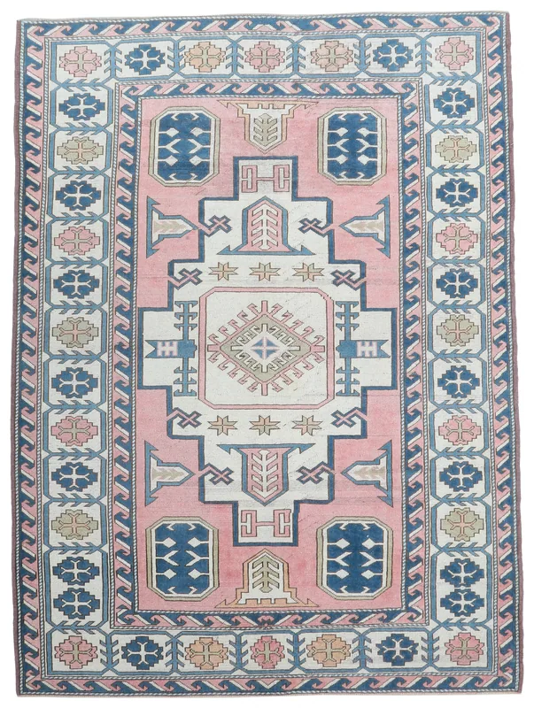 Full overhead view of the 6'9" x 9'2" vintage pink and navy geometric Anatolian rug