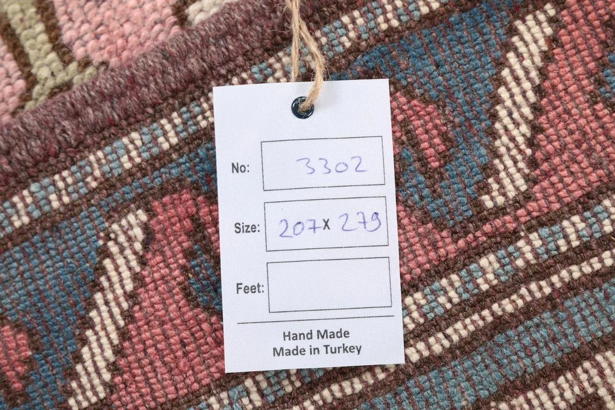 Close-up of the rug's back with a tag indicating origin from Turkey and size