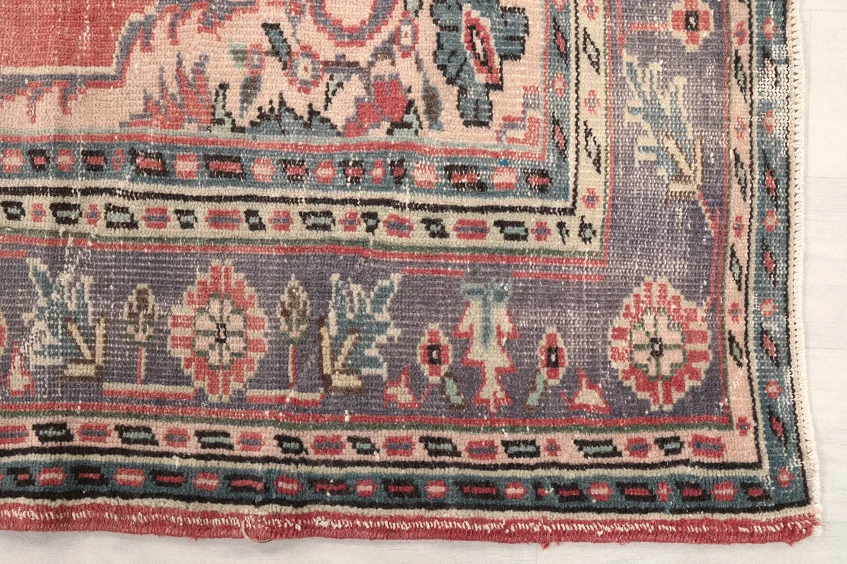 Close-up detail of the gray border with intricate floral and geometric patterns.