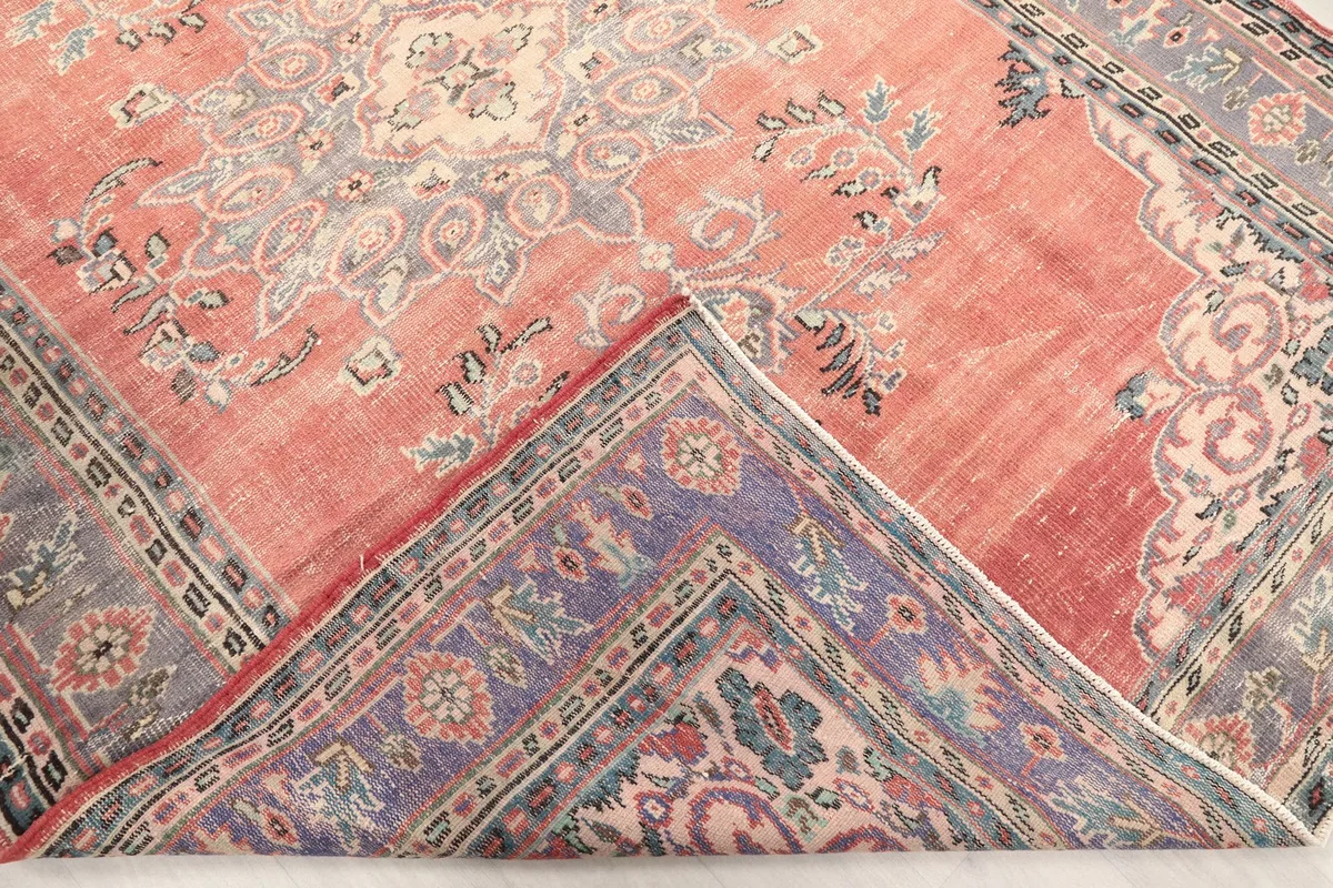 Folded corner showing the reverse side of the hand-knotted wool pile on cotton foundation.