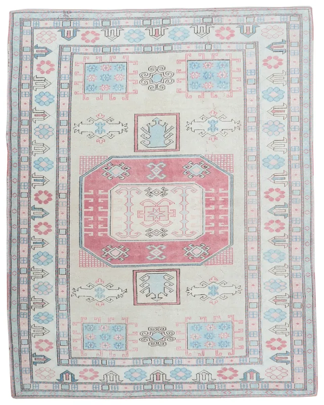 Full top view of the 7'1" x 9'1" ivory, rose, and blue geometric vintage Anatolian rug