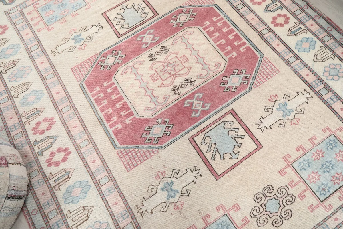 Overhead angle showing the rug's patterns and colors, including the central rose design