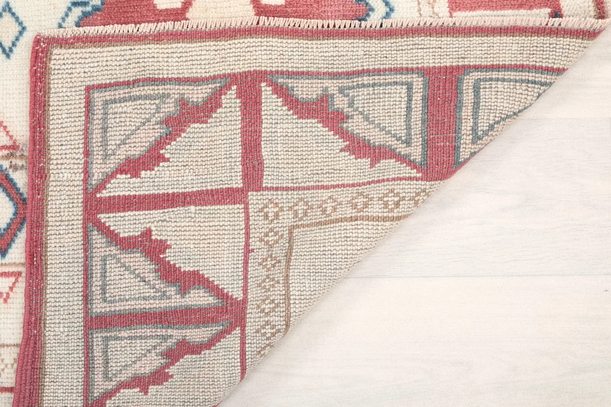 Underside of the rug, revealing the cotton foundation and hand-knotted construction.