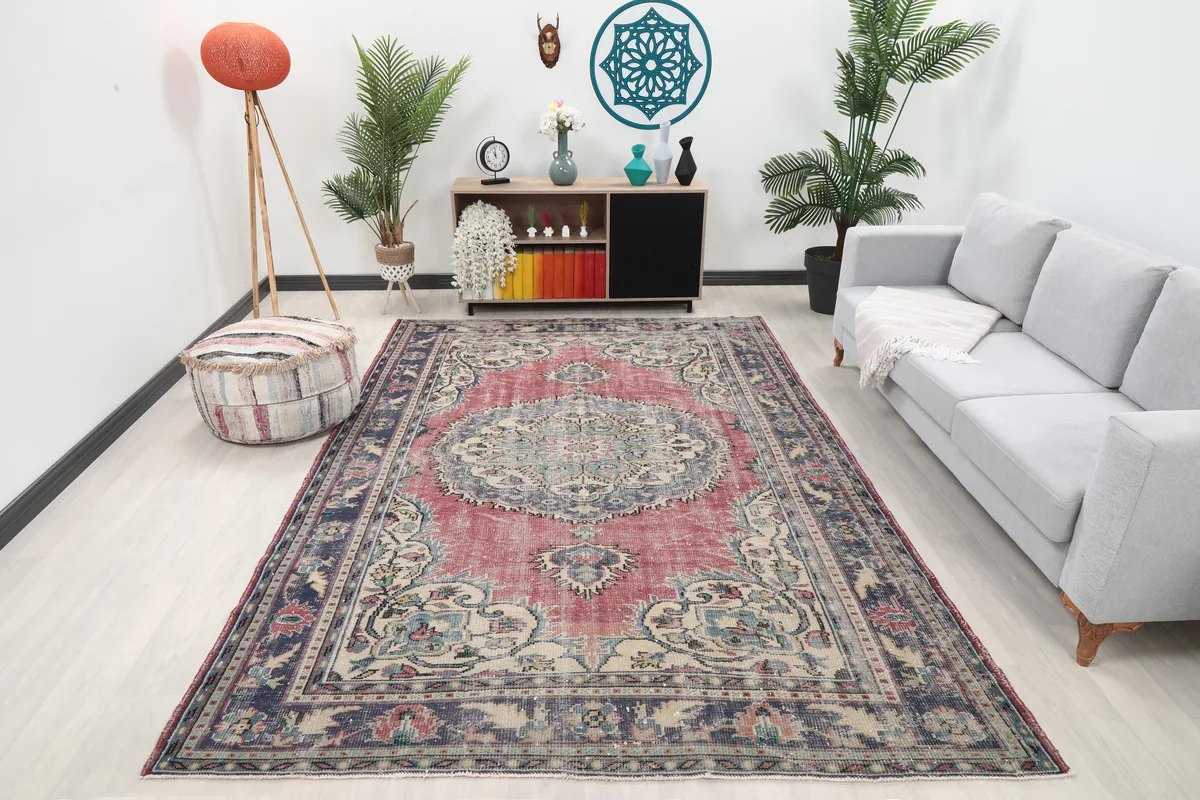 Faded Rose Medallion Anatolian Rug displayed in a living room setting, showing its scale next to a sofa