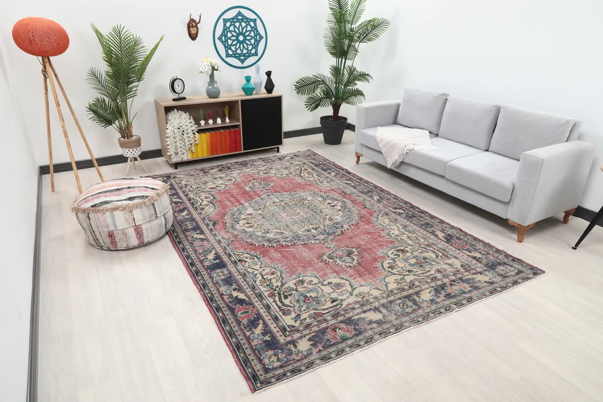 Angled view of the Faded Rose Medallion Anatolian Rug in a room, highlighting its colors and pattern