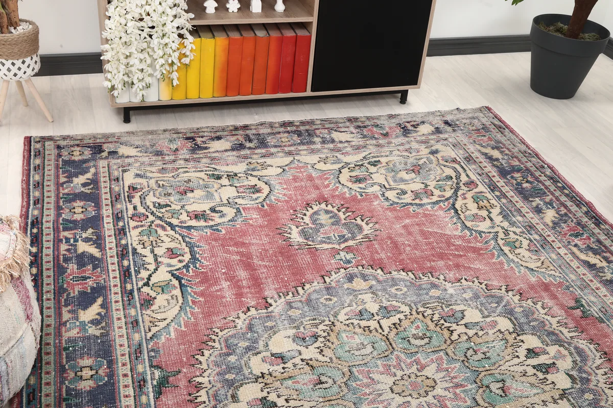 Close-up angled view of the Faded Rose Medallion Anatolian Rug, showing part of the central medallion and border