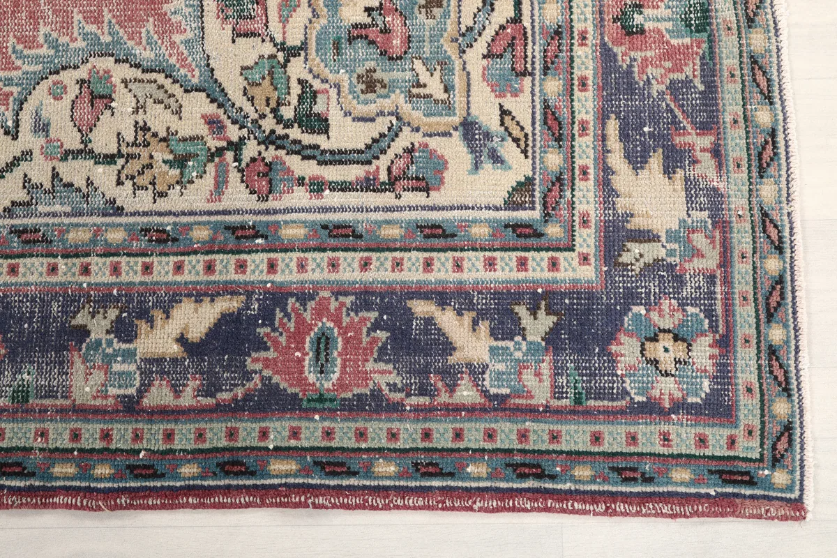 Detail of the navy border and corner design of the Faded Rose Medallion Anatolian Rug