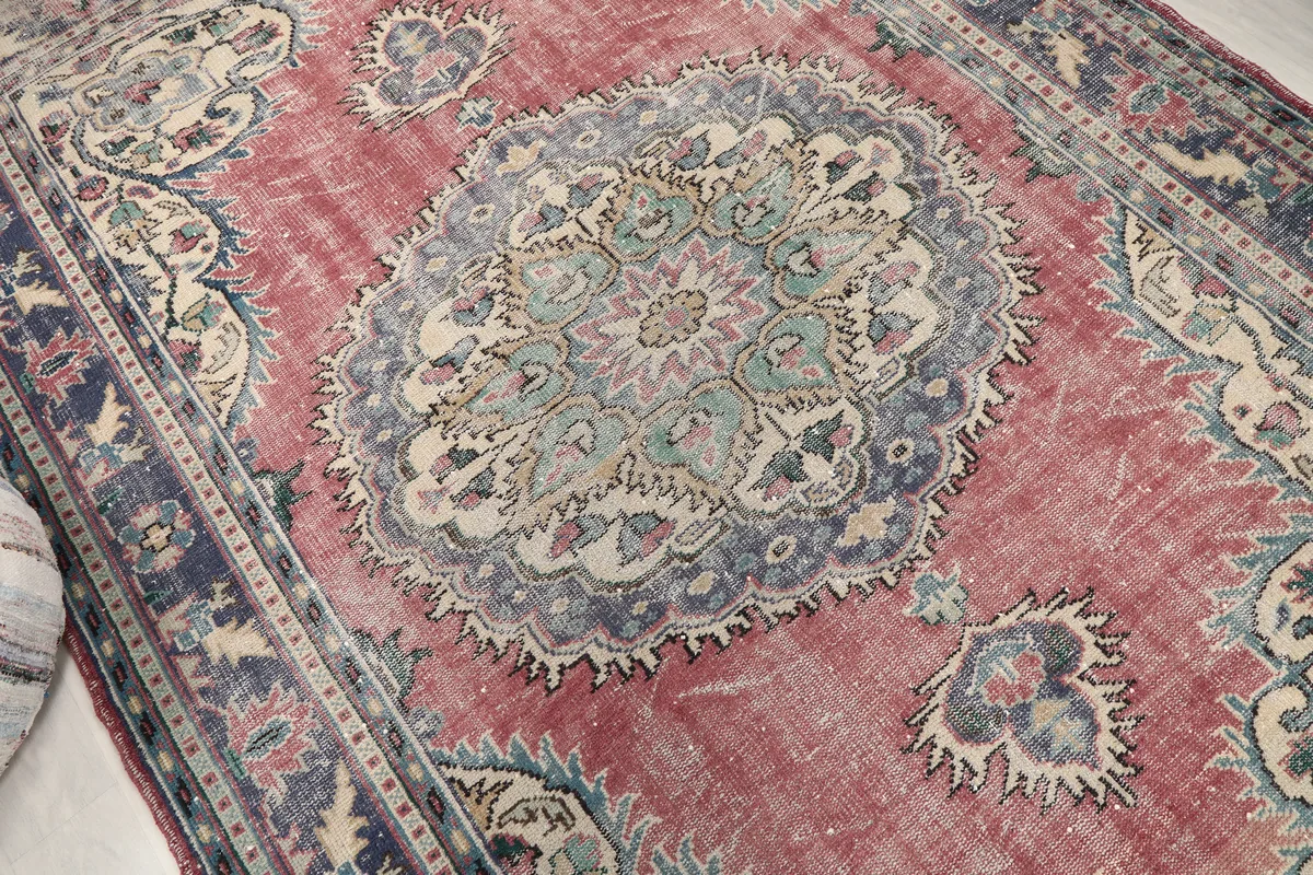 Close view of the Faded Rose Medallion Anatolian Rug's central design and field, showing distressed texture
