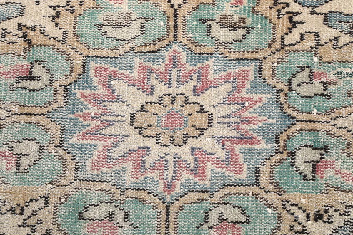 Detailed shot of the intricate floral motif within the central medallion of the Faded Rose Medallion Anatolian Rug