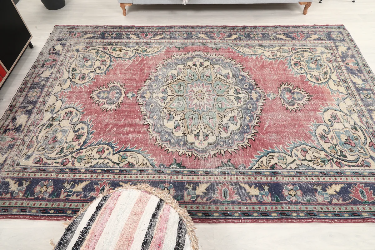 Slightly elevated view of the Faded Rose Medallion Anatolian Rug, showcasing the full pattern and distressed pile