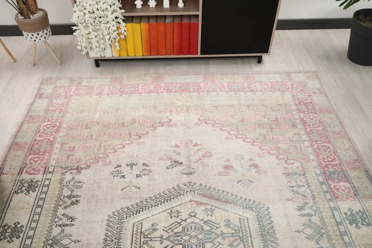 Angled view focusing on the upper portion of the rug, showing the faded rose border