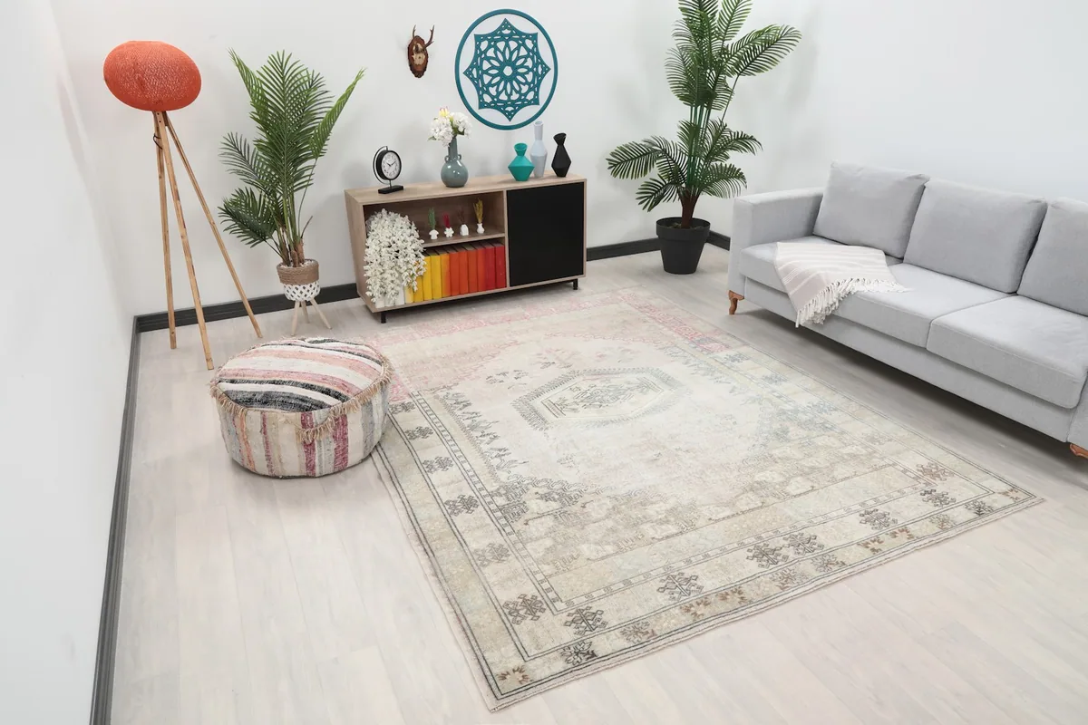 Angled view of the beige and rose rug showcasing its placement in a modern living space