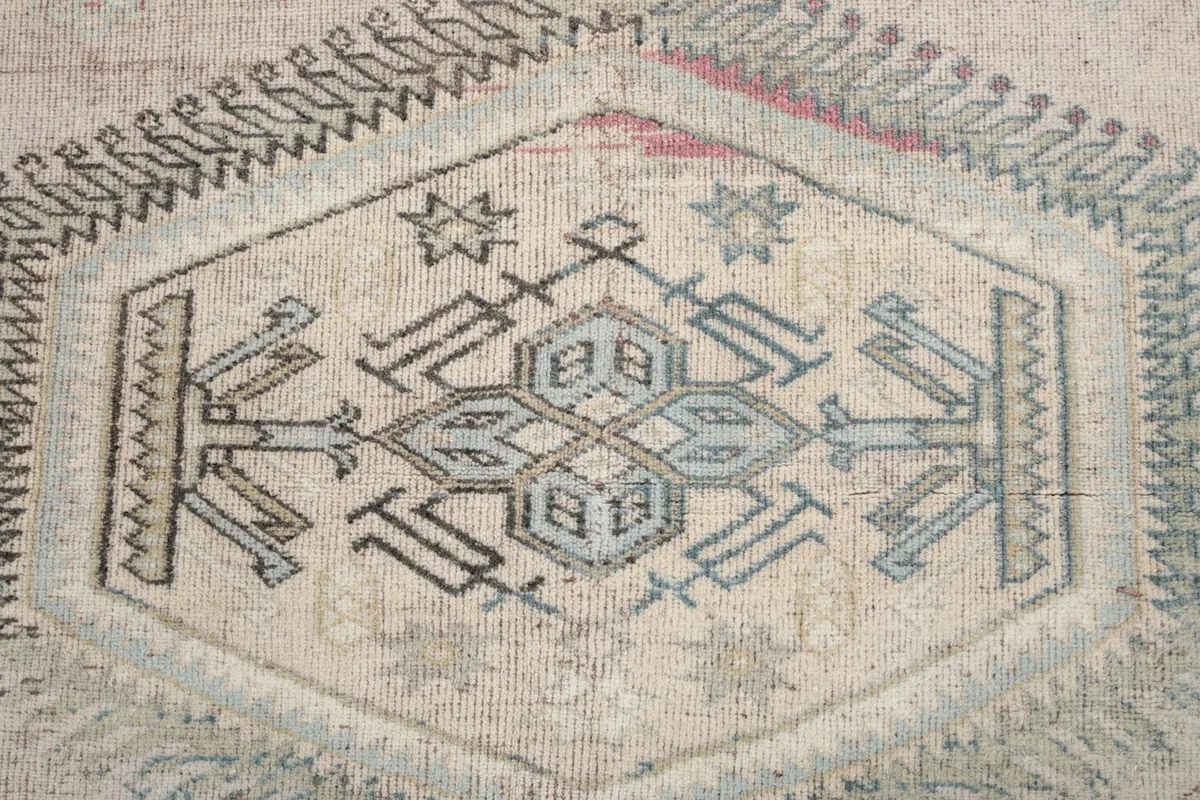 Detailed shot of the central geometric medallion with blue and gray motifs