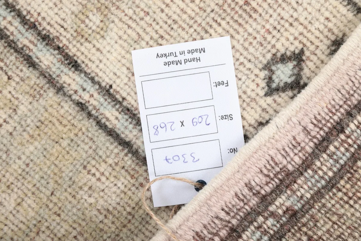 Close-up of the rug's label showing size and 'Hand Made in Turkey' details