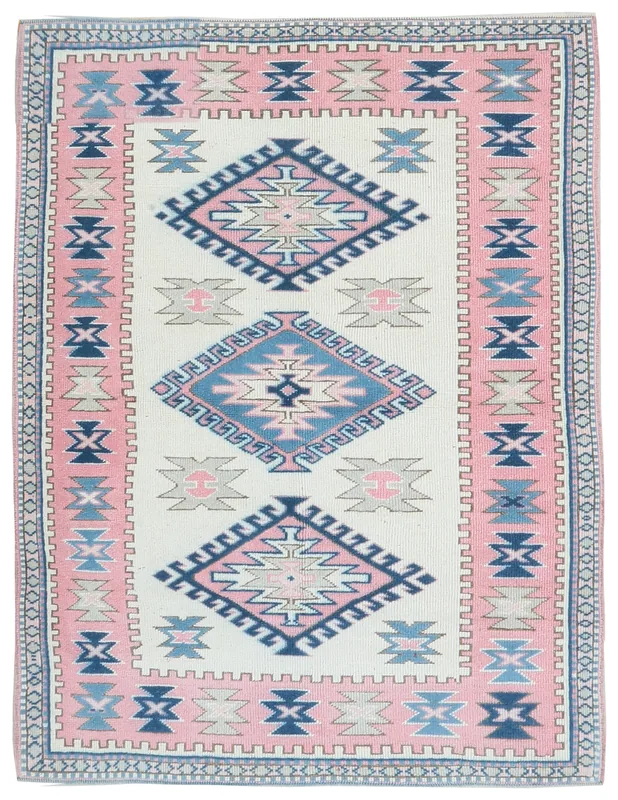 Full top view of the 4'3" x 5'9" ivory, pink, and blue vintage Anatolian rug with geometric tribal patterns
