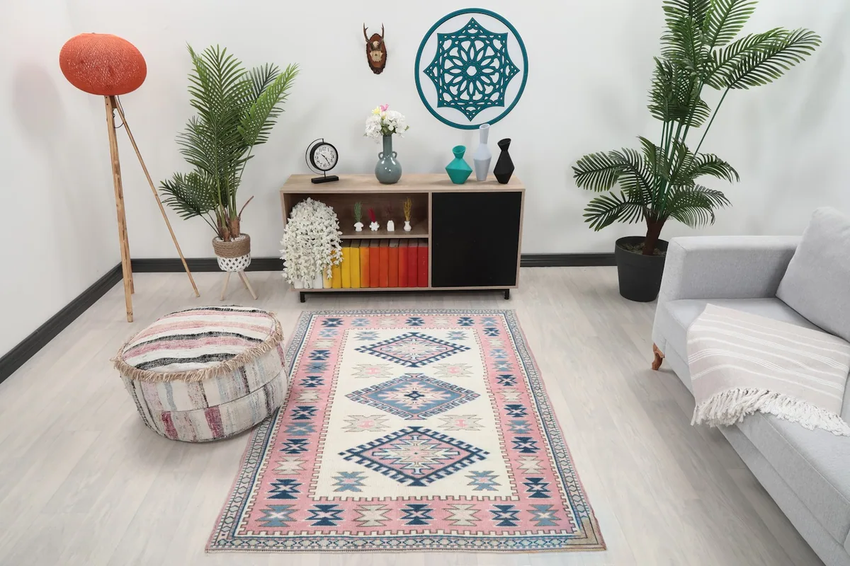 Vintage Anatolian rug placed in a modern living room setting with a couch and console table