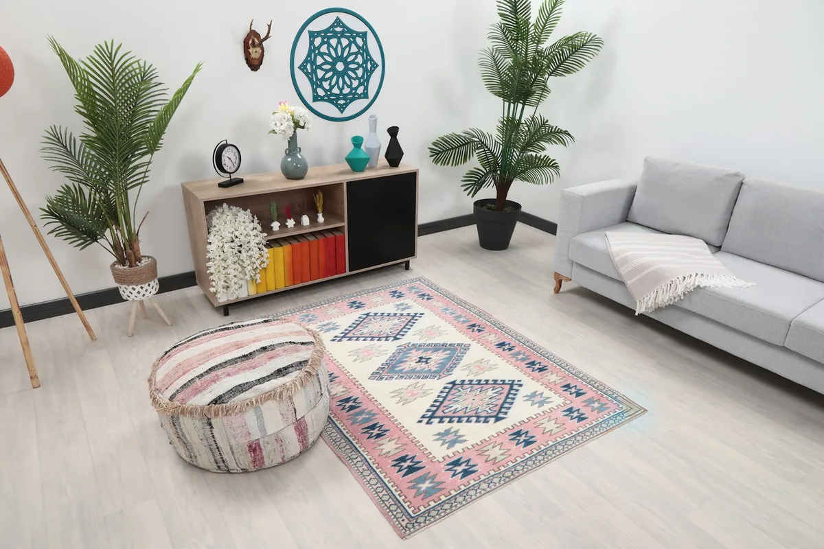 Overhead view of the ivory and pink rug in a room, showing its scale next to furniture