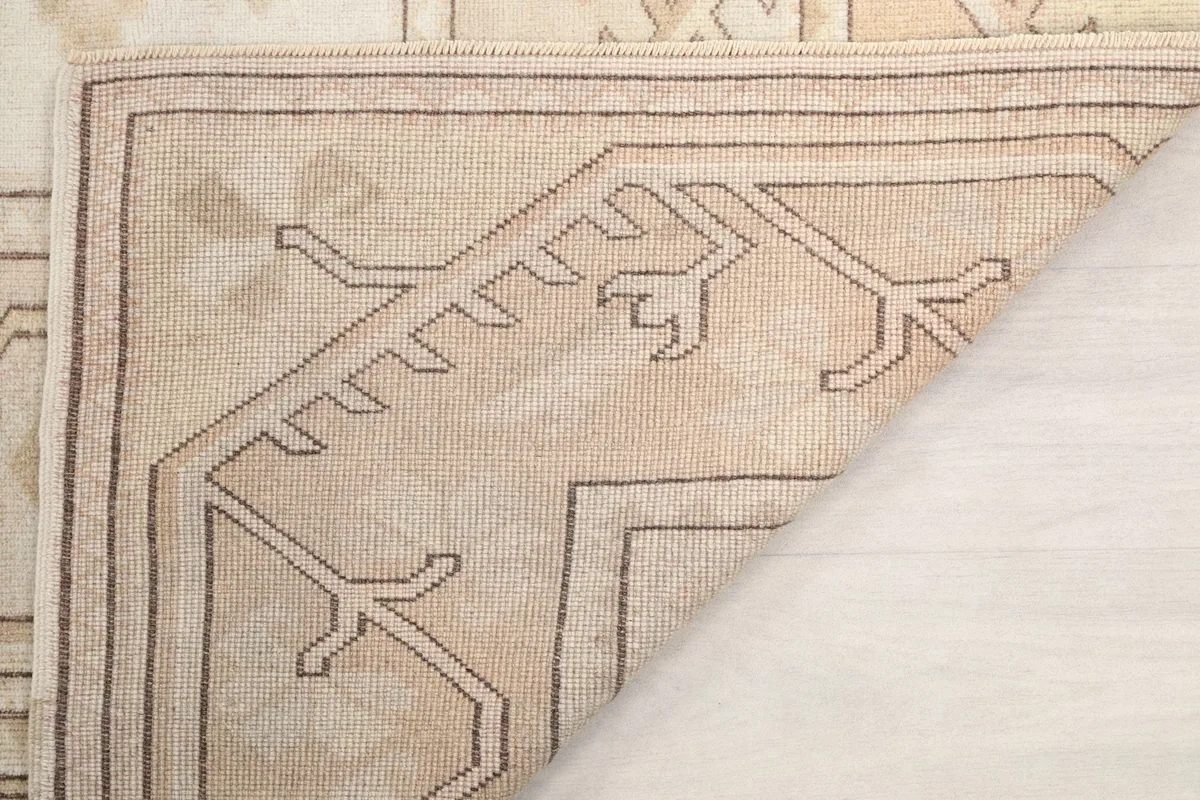Corner view of the rug's reverse side, revealing the knotting structure