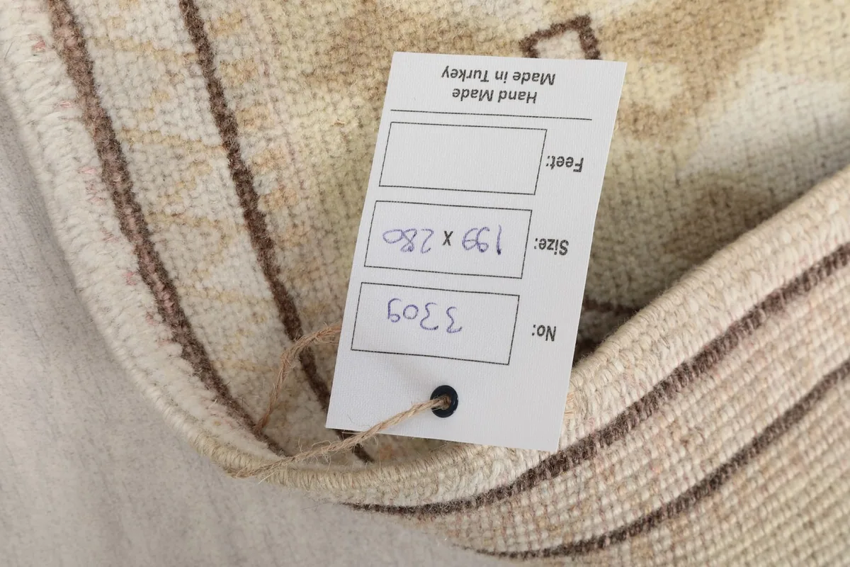 Tag showing the rug's size and origin, attached to the corner