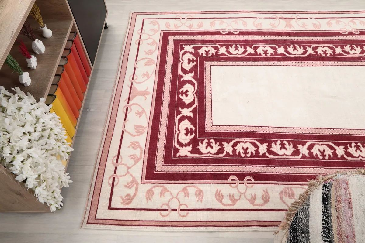 Side angle view of the rug in a room, capturing its overall design