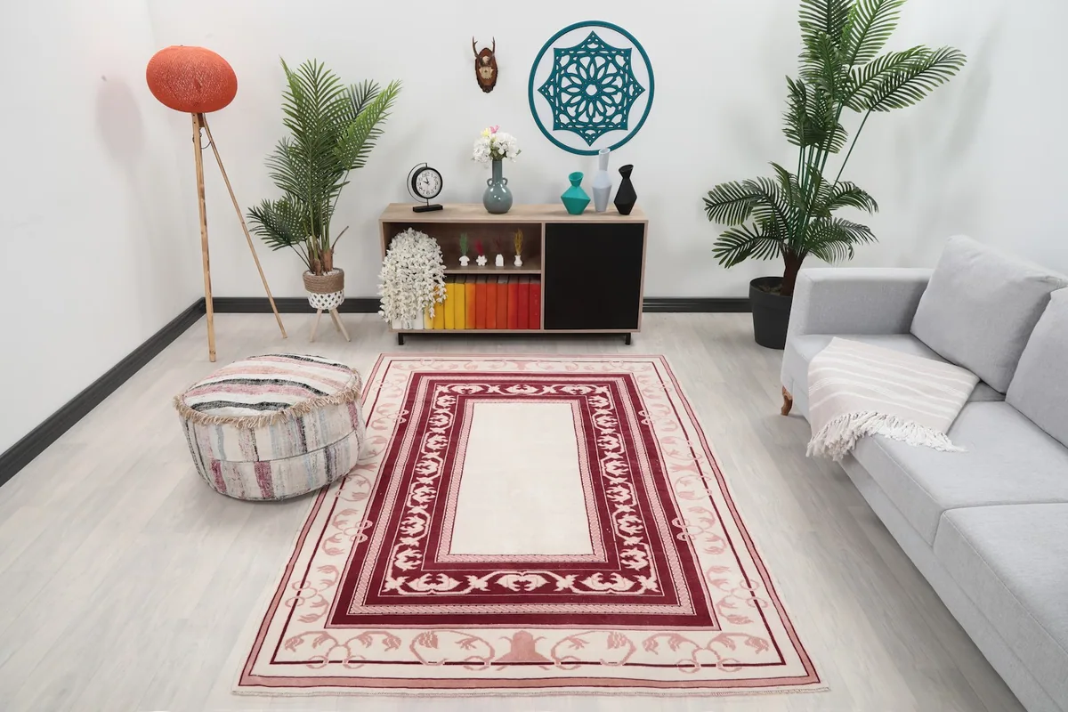Vintage Anatolian rug in a living room setting with a sofa and ottoman