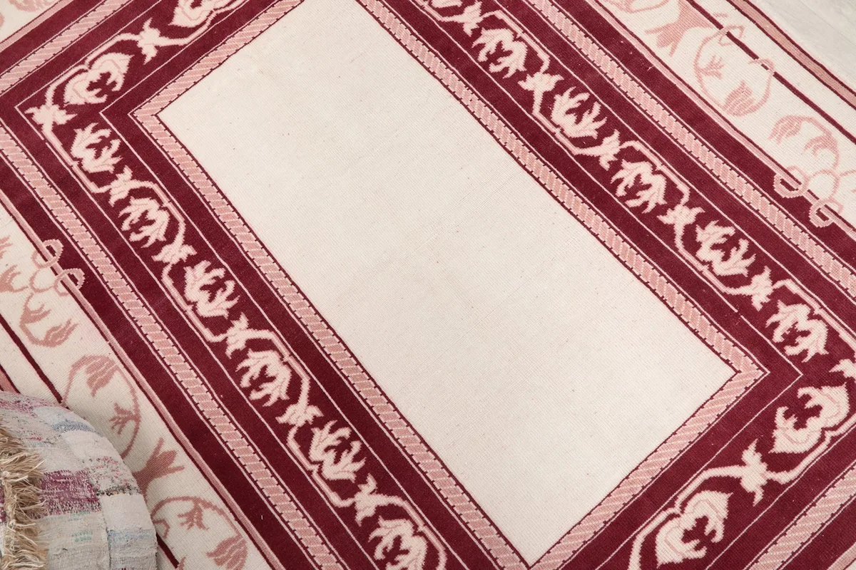Overhead view focusing on the central ivory field and inner red border