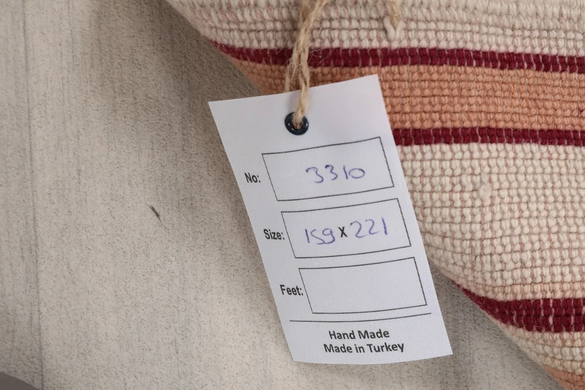 Tag showing the rug's dimensions in centimeters and 'Hand Made in Turkey'