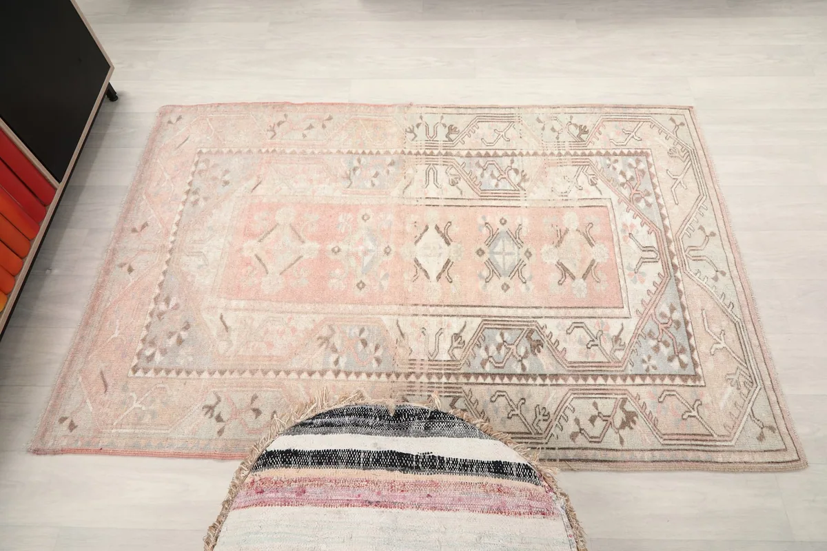 Top-down view of the entire rug, emphasizing its small size and decorative design in a room
