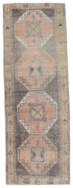 Full overhead view of the rose and brown geometric Anatolian runner on a white background