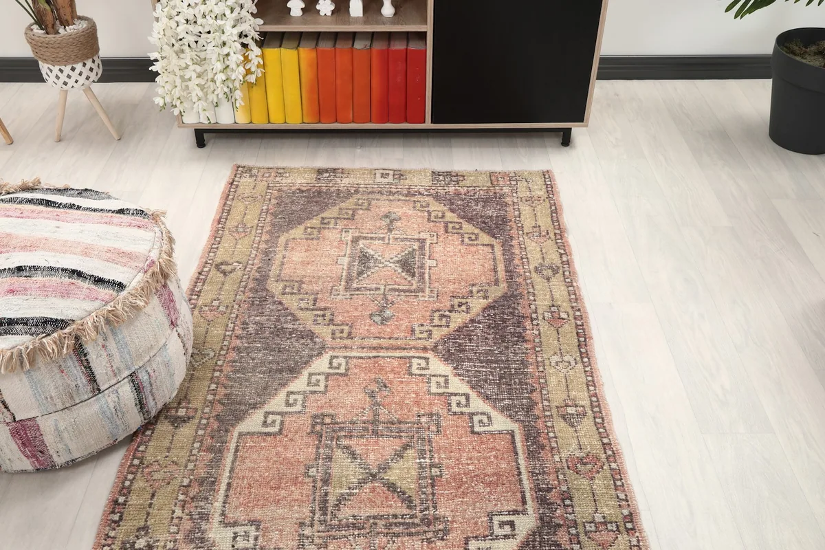 Overhead view of the runner in a room, showcasing its placement near a cabinet and ottoman
