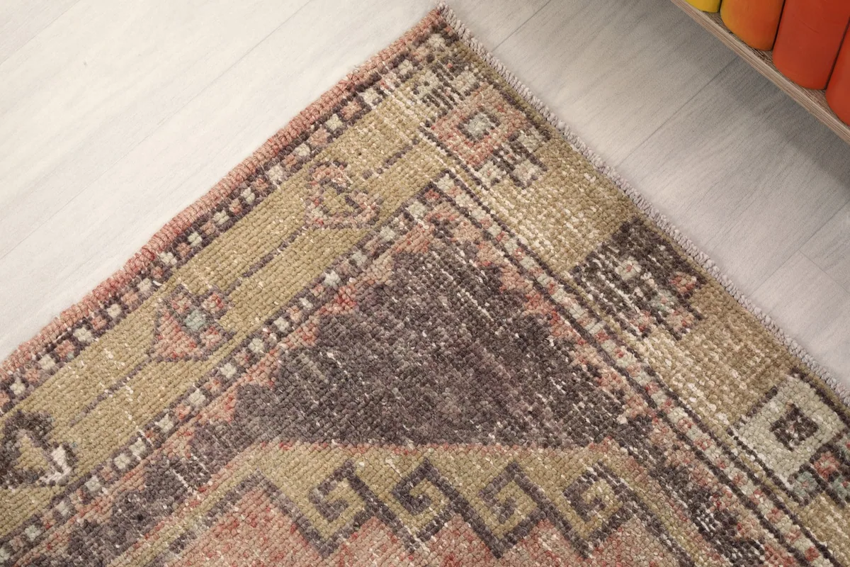 Close-up of the runner's end, revealing the distressed texture and color fading
