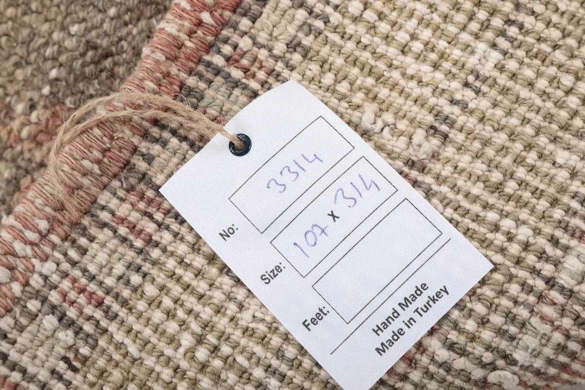 Close-up of the product tag indicating the rug's dimensions and origin