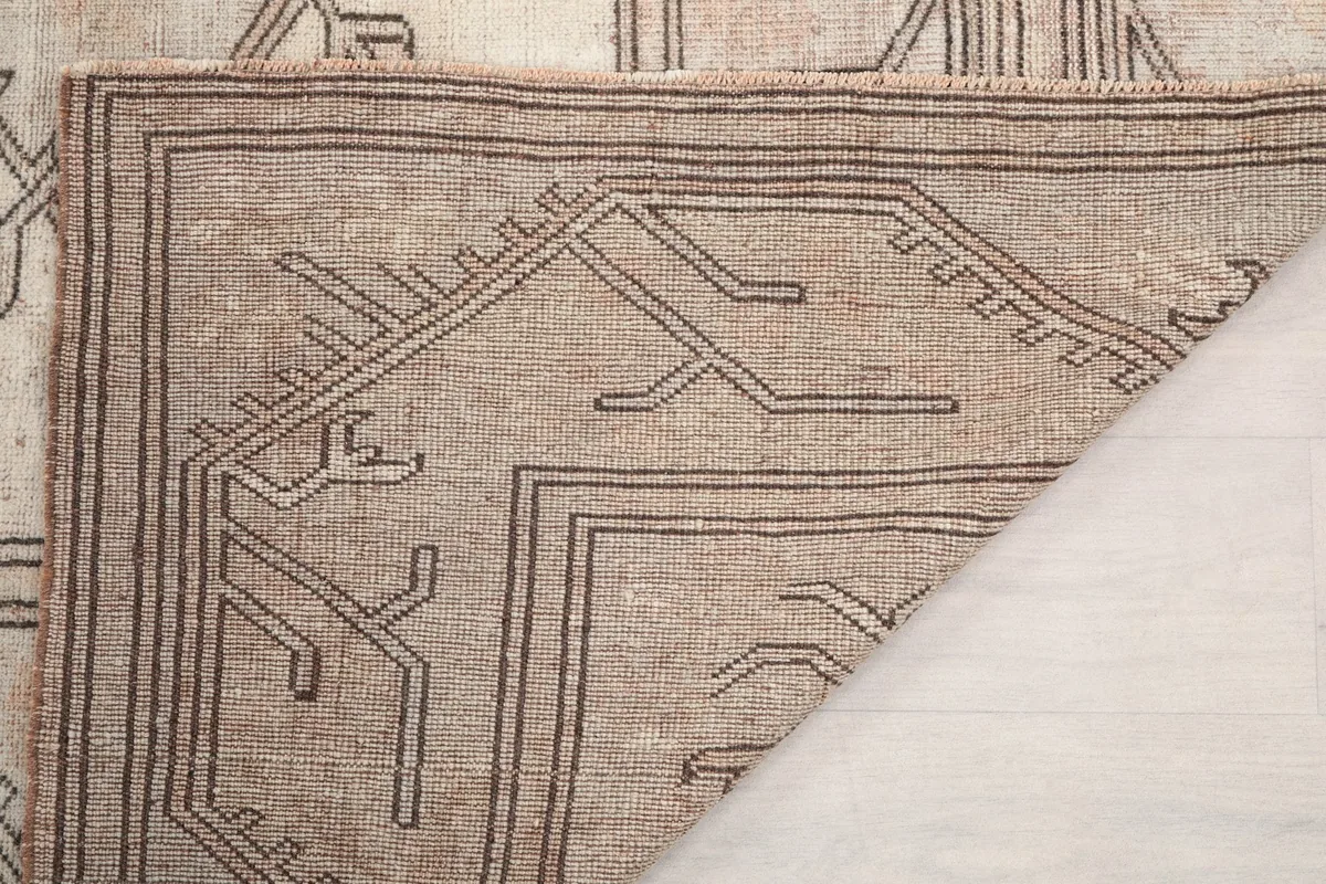 Underside view of the hand-knotted rug, revealing the tight cotton foundation