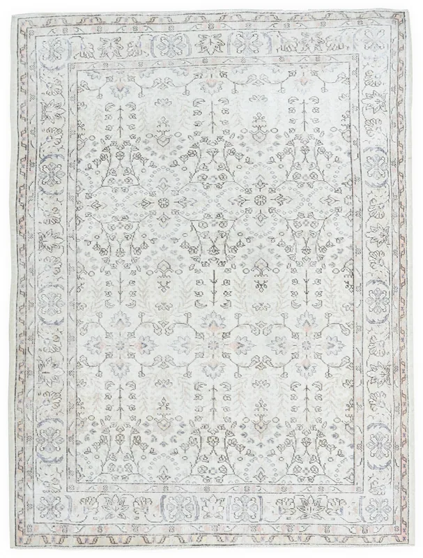 Full top view of the 5'9" x 7'10" ivory vintage Anatolian area rug with floral and geometric patterns