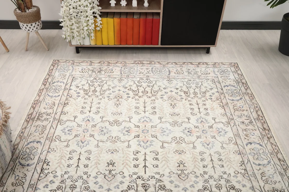View of the ivory vintage rug from above, showcasing its full pattern in a room setting