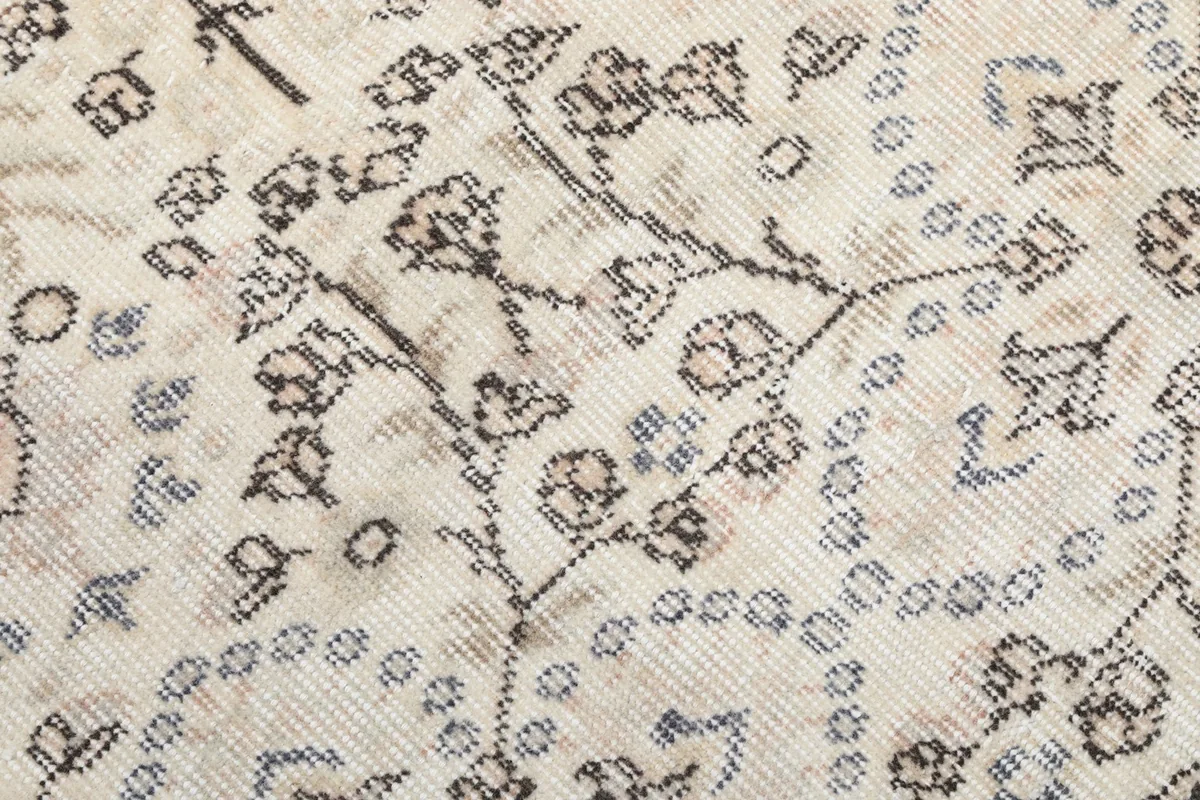 Close-up detail of the hand-knotted wool pile, showing individual knots and color variations