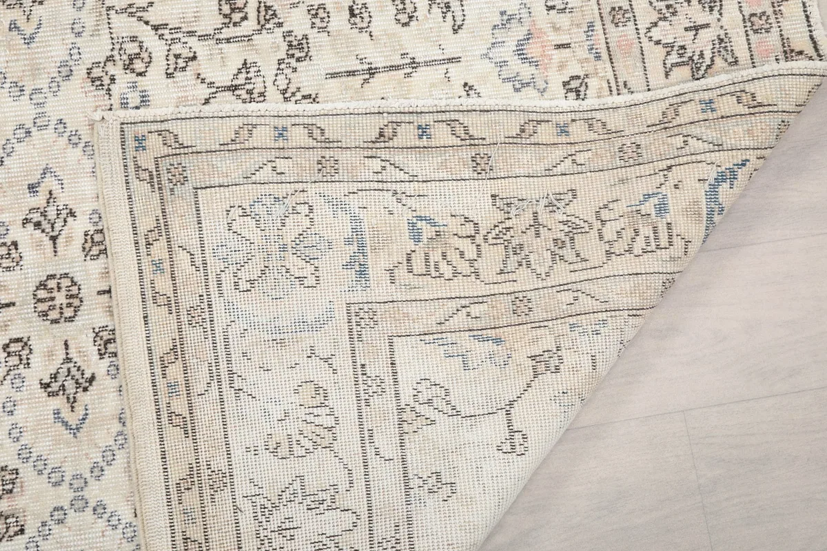 Detailed view of the rug's back, showing the hand-knotted construction and foundation