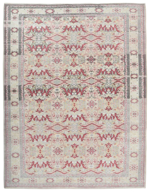 Full overhead view of the vintage Anatolian rug with ivory field and red geometric patterns