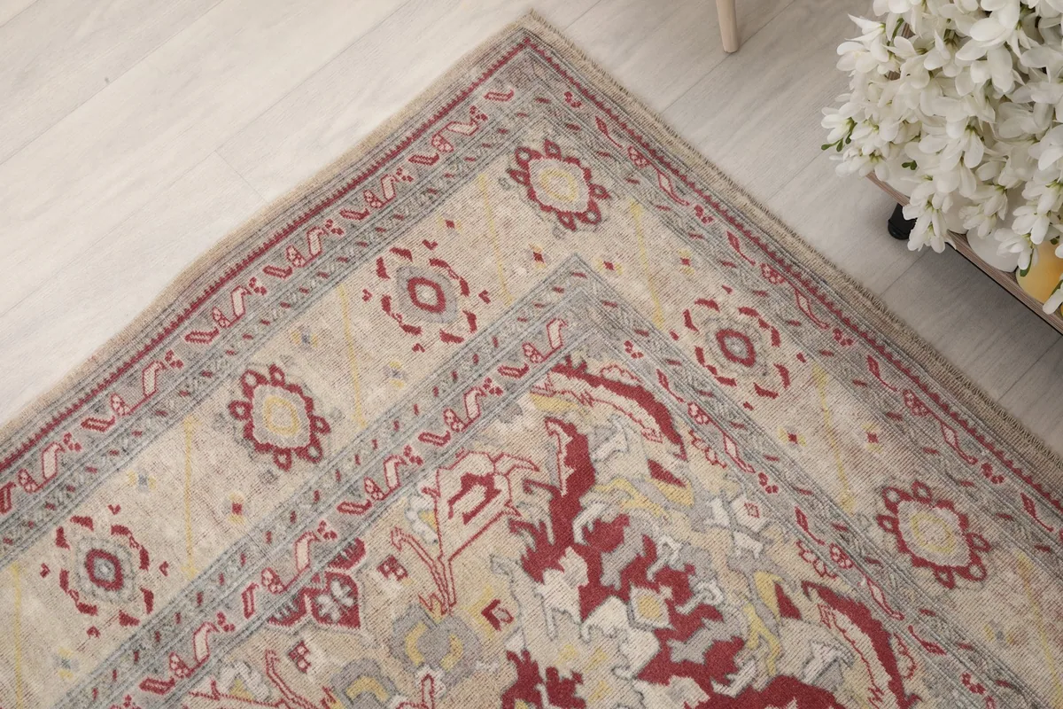 Corner detail of the rug, showing the border design and texture of the wool pile