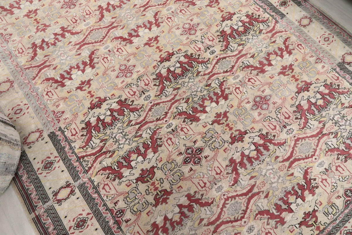 Overhead detail of the rug's central design, showcasing the red and gray geometric motifs