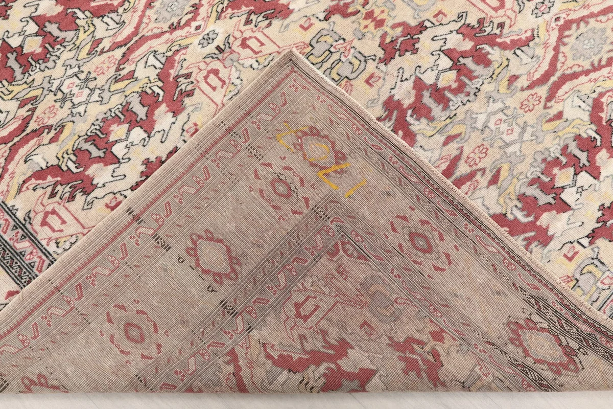 View of the rug's underside, revealing the hand-knotted construction and cotton foundation