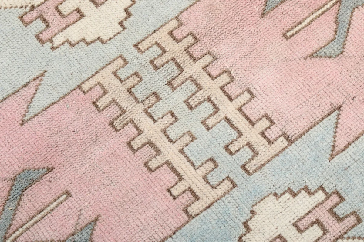 Close-up of the intricate geometric patterns and texture of the wool pile