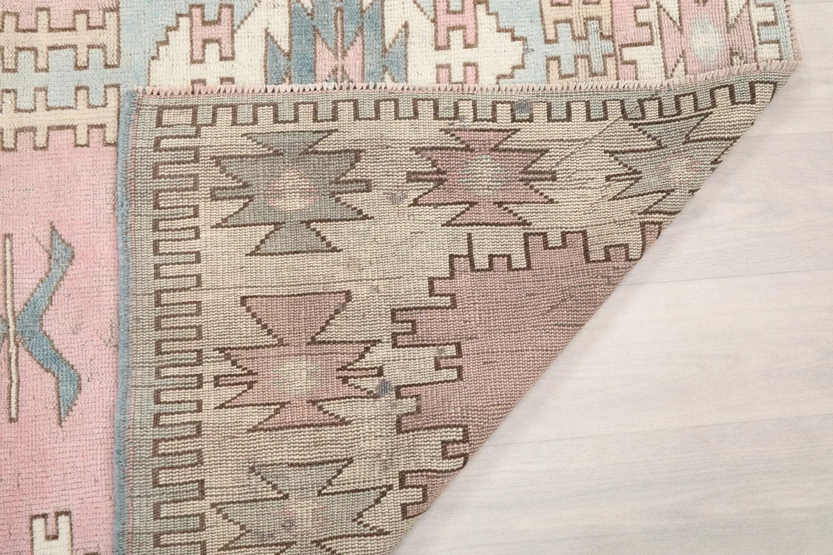 Reverse side of the rug, revealing the tightly woven cotton foundation and knotting