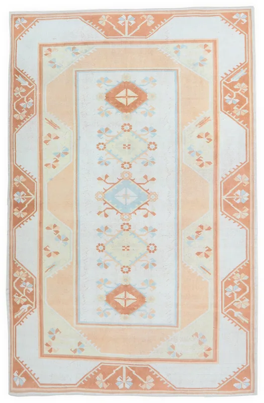 Full overhead view of the hand-knotted vintage Anatolian rug with cream field and orange border