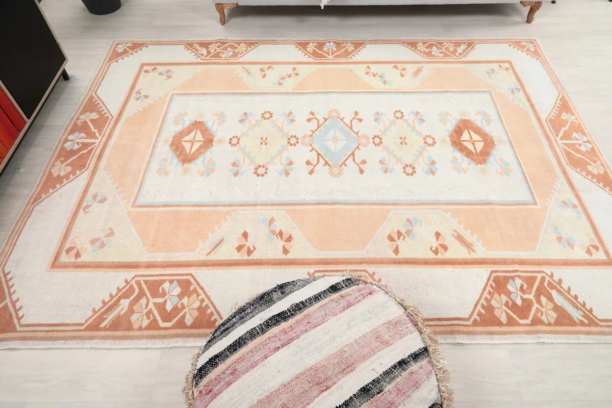 Overhead view of the rug, capturing its full pattern and color variations in a room setting